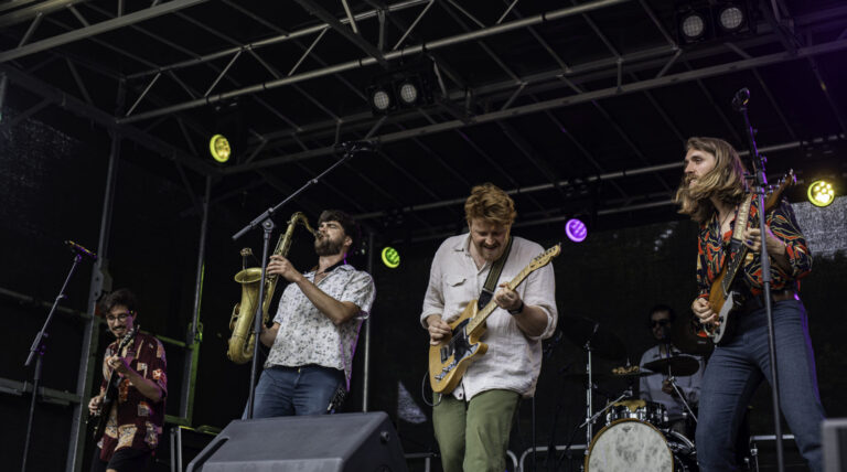 Biki Baya live at Surfana Festival, blending tropical indie, Latin grooves, and soulful folk, as festival-goers dance barefoot in the sand, soaking in the vibrant rhythms.